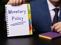 Financial concept meaning Monetary Policy with sign on white notepad Royalty Free Stock Photo