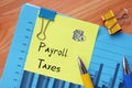 Financial concept meaning Payroll Taxes with phrase on the piece of paper