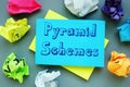 Financial concept meaning Pyramid Schemes with sign on the piece of paper