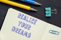 Financial concept meaning REALIZE YOUR DREAMS with inscription on the sheet Royalty Free Stock Photo