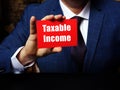 Financial concept meaning Taxable Income with phrase on red business card