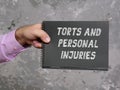 Financial concept meaning TORTS AND PERSONAL INJURIES with inscription on the sheet Royalty Free Stock Photo