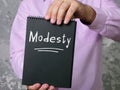 Financial concept about Modesty with sign on the piece of paper Royalty Free Stock Photo