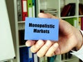 Financial concept about Monopolistic Markets with inscription on the blue business card