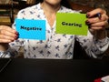 Financial concept about Negative Gearing with sign on green and blue business cards in hand