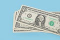 One US dollar bills on a blue background. Royalty Free Stock Photo