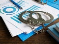 Financial crime concept. Handcuffs and folder with audit report. Royalty Free Stock Photo