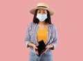 Portrait of sad asian woman in mask showing empty wallet Royalty Free Stock Photo