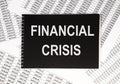 Financial crisis inscription on black paper among financial documents