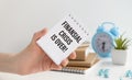 FINANCIAL CRISIS IS OVER, business concept. text on notebook paper in hand Royalty Free Stock Photo