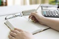 Financial data analyzing. Counting on calculator. Hand with pen Royalty Free Stock Photo