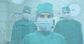 Financial data processing against portrait of team of surgeons wearing face masks Royalty Free Stock Photo