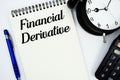 Financial Derivative text written on notepad with calculator and alarm clock Royalty Free Stock Photo