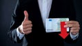 Financial expert holding euro banknotes, showing thumbs up and down, falling Royalty Free Stock Photo