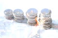 Double exposure of row of coins and cityscape at nigth with volume diagram