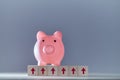 Financial growth. Increase in income. Saving money. Pink piggy bank on wooden cubes with up arrows sign, copy space