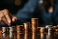 Financial growth male hand stacks coins, symbolizing saving money concept