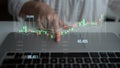 Financial Growth Visualization with Market Analysis Hand Gestures Over Laptop Keyboard in a Modern Workspace Displaying Royalty Free Stock Photo