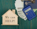 Financial helping concept - little house with text We can help!, keys, calculator, passport, money Royalty Free Stock Photo