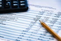 Financial income statement with calculator and pencil Royalty Free Stock Photo