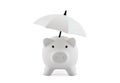 Financial insurance. White piggy bank with umbrella isolated on white background Royalty Free Stock Photo