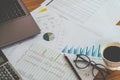 Financial Management concept, Calculator and many documents of personal budget with a laptop on the table.