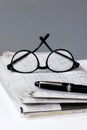 Financial newspaper break background with pen and glasses business man Royalty Free Stock Photo
