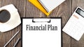 FINANCIAL PLAN text on paper with coffee, calculator and notebook. Business concept Royalty Free Stock Photo