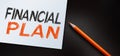 Financial plan text written on notebook and orange pencil. Business concept Royalty Free Stock Photo