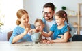 Financial planning family mother father and children with piggy Bank at home