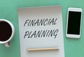 FINANCIAL PLANNING, message on paper, smart phone and coffee on table Royalty Free Stock Photo