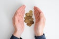 Financial problems, crisis, falling value of money, poverty, poor concept. Hands holding, saving stack of golden coins