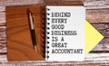 Financial quote Behind Every Good Business Is A Great Accountant handwritten on yellow sticky note on laptop keyboard