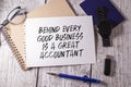 Financial quote Behind Every Good Business Is A Great Accountant handwritten on yellow sticky note on laptop keyboard