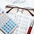 Financial report - calculator, glasses and papers