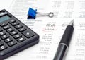 Financial report with calculator and pen Royalty Free Stock Photo