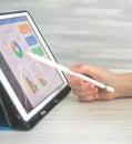 Financial results and company perfomance on digital tablet using wireless stylus pen. Business diagram on the screen