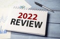 Financial review 2022 concept on wooden background Royalty Free Stock Photo
