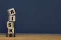 Financial risk management concept. Wooden block stacked on gold coins and copy space Royalty Free Stock Photo