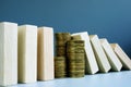 Financial stability concept. Stack of coins and domino effect Royalty Free Stock Photo