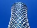 Financial success concept. Modern skyscraper on blue background with copyspace (Qipco Tower, Tornado Tower