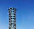 Financial success concept. Modern skyscraper on blue background with copyspace (Qipco Tower, Tornado Tower