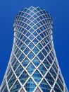 Financial success concept. Modern skyscraper on blue background (Qipco Tower, Tornado Tower), macro