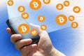 financial technology and internet money - smartphone in a hand and Bitcoin sign BTC