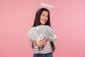 Financial wealth. Portrait of happy smiling girl with halo over head holding out money to camera Royalty Free Stock Photo