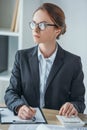 financier working at table in office with calculator