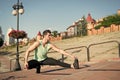 Find balance. Man workout outdoors urban background. You should stretch muscles after workout to achieve best result