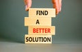 Find a better solution symbol. Concept words Find a better solution on wooden blocks. Beautiful grey table grey background.