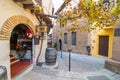 Find charming cafes, shops, & here, a delightful wine store with brick arch entry in narrow alley.