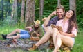 Find companion to travel and hike. Friends relaxing near campfire after day hiking or gathering mushrooms. Summer
